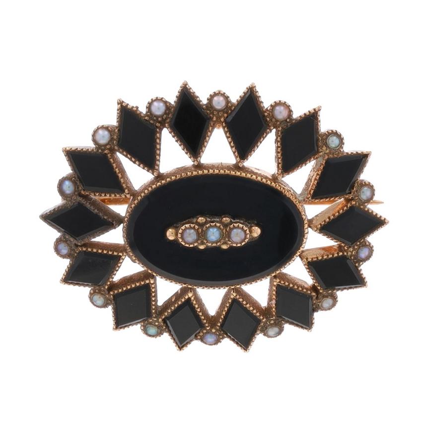 Era: Edwardian
Date: 1900s - 1910s

Metal Content: 10k Yellow Gold

Stone Information

Natural Onyx
Color: Black

Natural Seed Pearls

Style: Convertible Brooch/Pendant
Fastening Type: HInged Pin and Locking C-Clasp
Theme: Floral Starburst
Features: