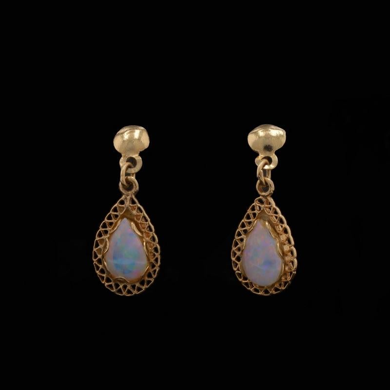 Metal Content: 14k Yellow Gold

Stone Information

Natural Opals
Carat(s): .52ctw
Cut: Pear Cabochon

Total Carats: .52ctw

Style: Dangle
Fastening Type: Butterfly Closures
Features: Open Cut Borders

Measurements

Tall: 13/16
