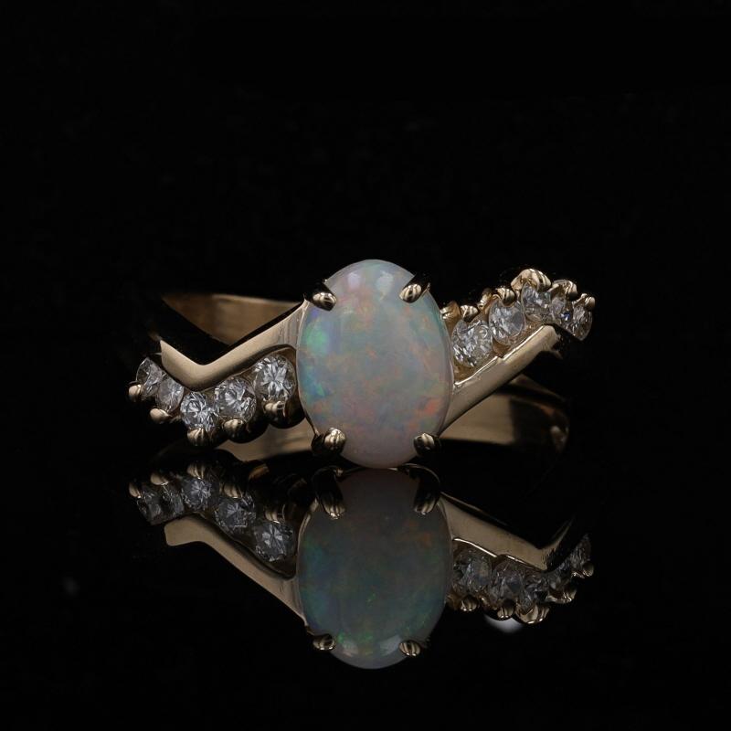 Size: 7 1/4
Sizing Fee: Up 2 sizes for $35 or Down 1 size for $35

Metal Content: 14k Yellow Gold

Stone Information

Natural Opal
Carat(s): 1.10ct
Cut: Oval Cabochon
Stone Note: (Australian)

Natural Diamonds
Carat(s): .25ctw
Cut: Round