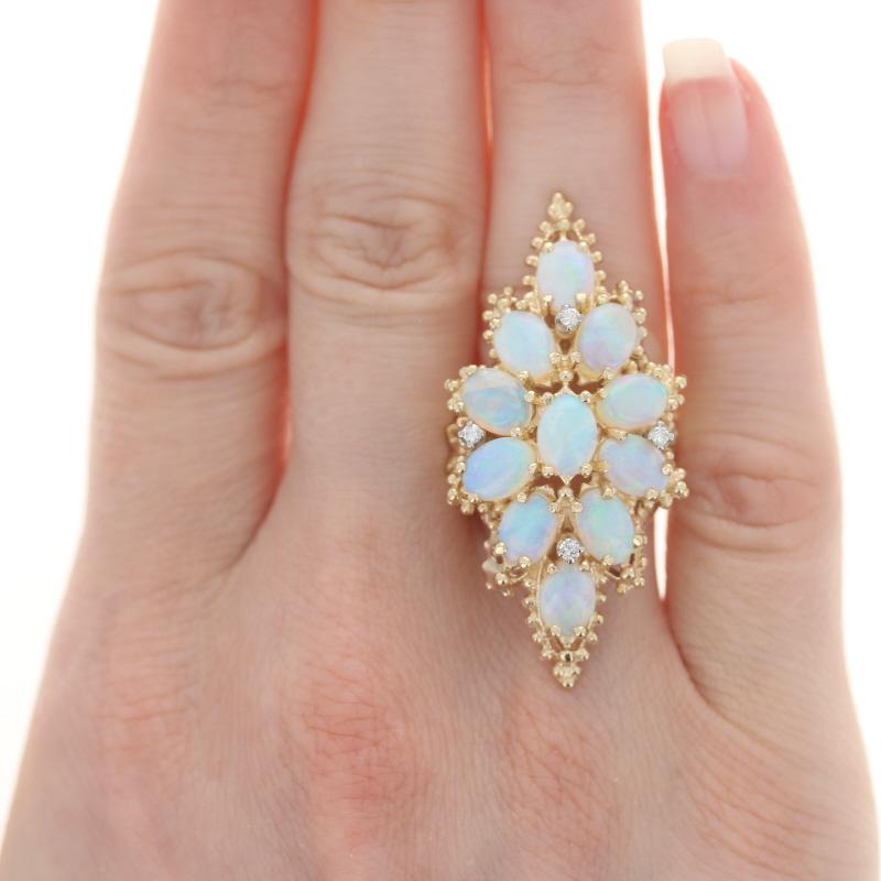 Size: 5 3/4
Sizing Fee: Down 2 sizes for $30 & up 2 sizes for $35

Metal Content: 14k Yellow Gold & 14k White Gold

Stone Information

Natural Opal
Carat(s): 6.80ctw
Cut: Oval Cabochon

Natural Diamonds
Carat(s): .08ctw
Cut: Round Brilliant
Color: H