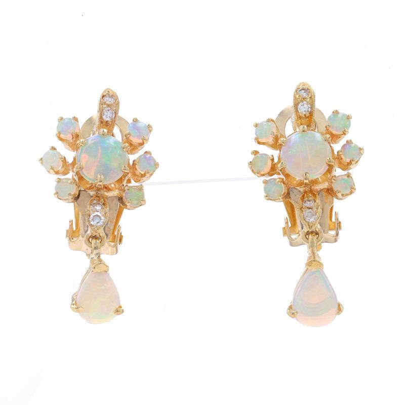 Metal Content: 14k Yellow Gold

Stone Information

Natural Opals
Carat(s): 1.50ctw
Cut: Round Cabochon & Pear Cabochon

Natural Diamonds
Carat(s): .12ctw
Cut: Single
Color: H - I
Clarity: VS1 - VS2

Total Carats: 1.62ctw

Style: Dangle
Fastening
