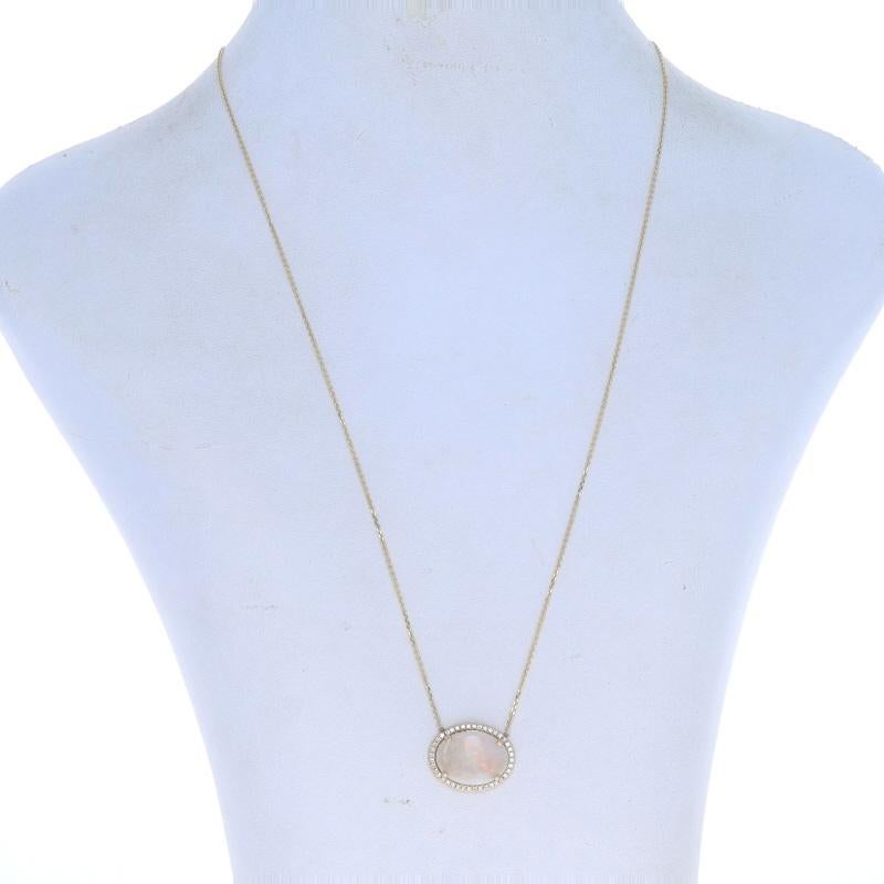 Metal Content: 14k Yellow Gold

Stone Information

Natural Opal
Carat(s): 3.66ct
Cut: Oval Cabochon
Origin: Australia

Natural Diamonds
Carat(s): .18ctw
Cut: Round Brilliant
Color: F - G
Clarity: VS1 - VS2

Total Carats: 3.84ctw

Style: Halo
Chain