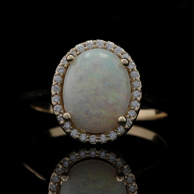 Size: 7
Sizing Fee: Up or Down 2 sizes for $25

Metal Content: 14k Yellow Gold 

Stone Information: 
Genuine Australian Opal
Carat: 1.65ct
Cut: Oval Cabochon
Size: 10.3mm x 8.2mm

Natural Diamonds  
Carats: .12ctw
Cut: Round Brilliant 
Color: G 