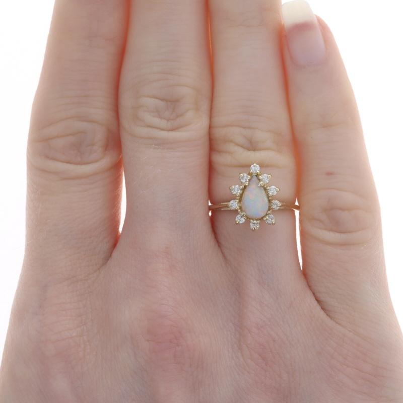 Size: 4 1/2
Sizing Fee: Up 2 sizes for $30 or Down 1 size for $30

Metal Content: 14k Yellow Gold

Stone Information
Natural Opal
Carat(s): .55ct
Cut: Pear Cabochon
Origin: Australia

Natural Diamonds
Carat(s): .20ctw
Cut: Single
Color: H -