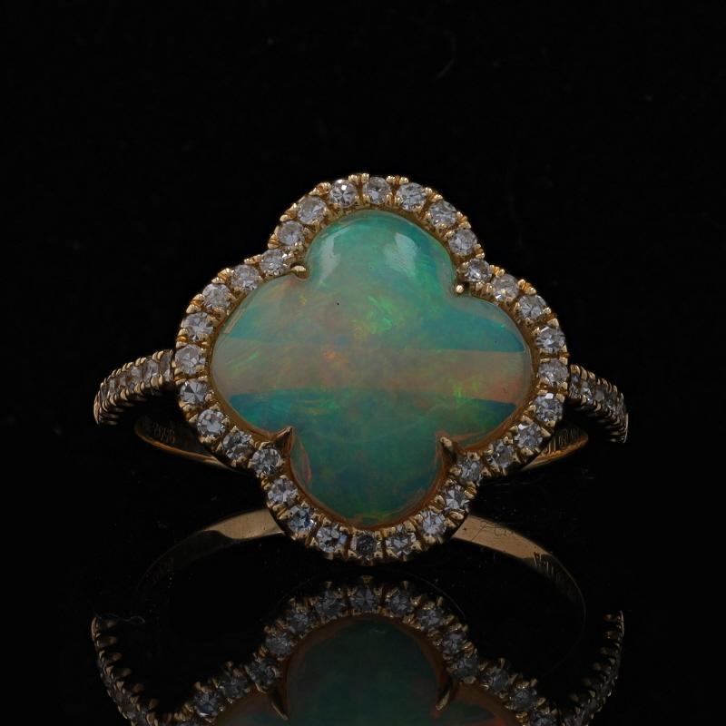 Size: 7 1/4

Metal Content: 14k Yellow Gold

Stone Information
Natural Opal
Carat(s): 1.74ct
Cut: Quatrefoil Cabochon
Origin: Ethiopian

Natural Diamonds
Carat(s): .29ctw
Cut: Single
Color: G - H
Clarity: SI1

Total Carats: 2.03ctw

Style: Solitaire