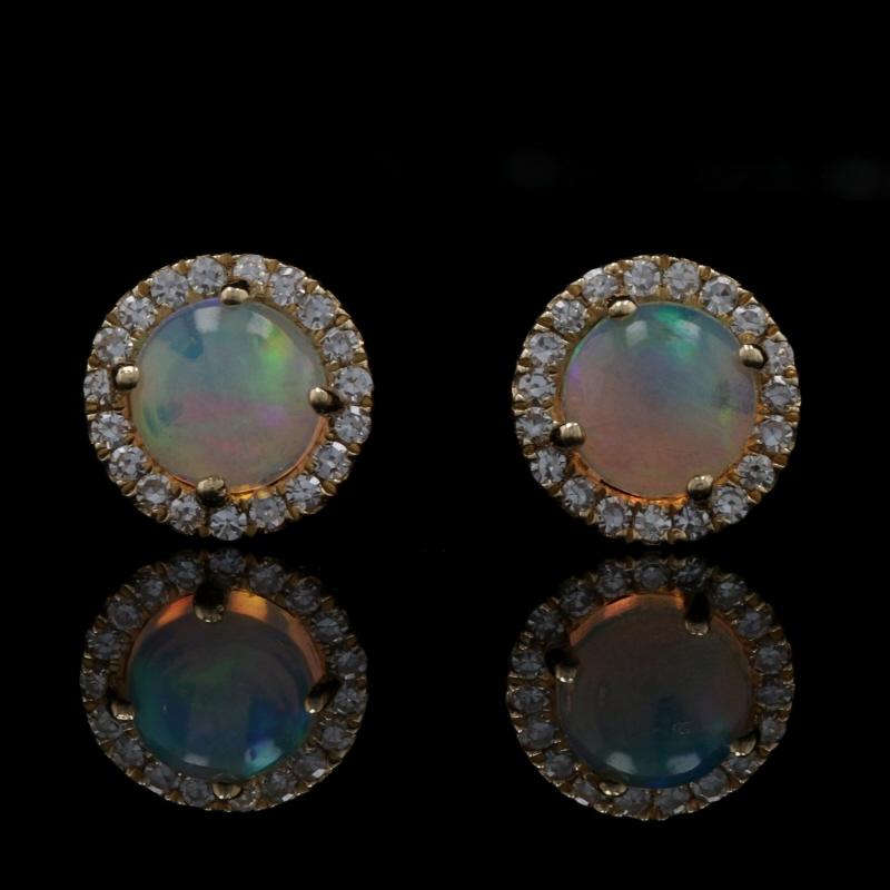 Metal Content: 14k Yellow Gold 

Stone Information: 
Genuine Australian Opals
Carats: .40ctw
Cut: Round Cabochon

Natural Diamonds
Carats: .08ctw
Cut: Single
Color: F - G
Clarity: VS1 - VS2

Total Carats: .48ctw

Style: Halo Stud 
Fastening Type: