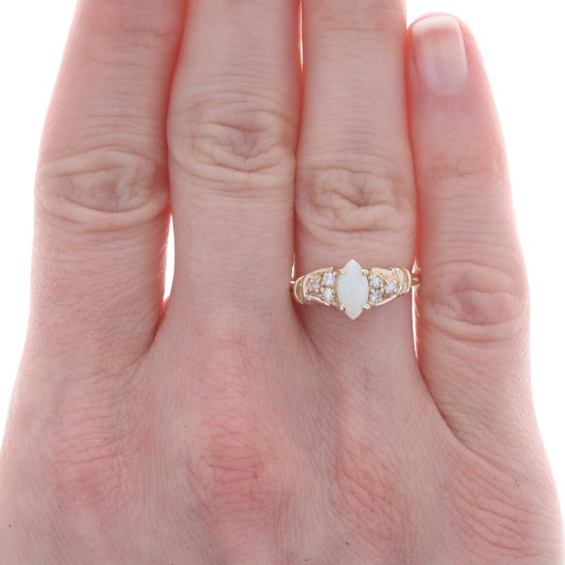 Size: 6 1/4
Sizing Fee: Up 2 sizes for $35 or Down 2 sizes for $30

Metal Content: 14k Yellow Gold

Stone Information
Natural Opal
Carat(s): .40ct
Cut: Marquise Cabochon

Natural Diamonds
Carat(s): .12ctw
Cut: Round Brilliant
Color: H - I
Clarity: