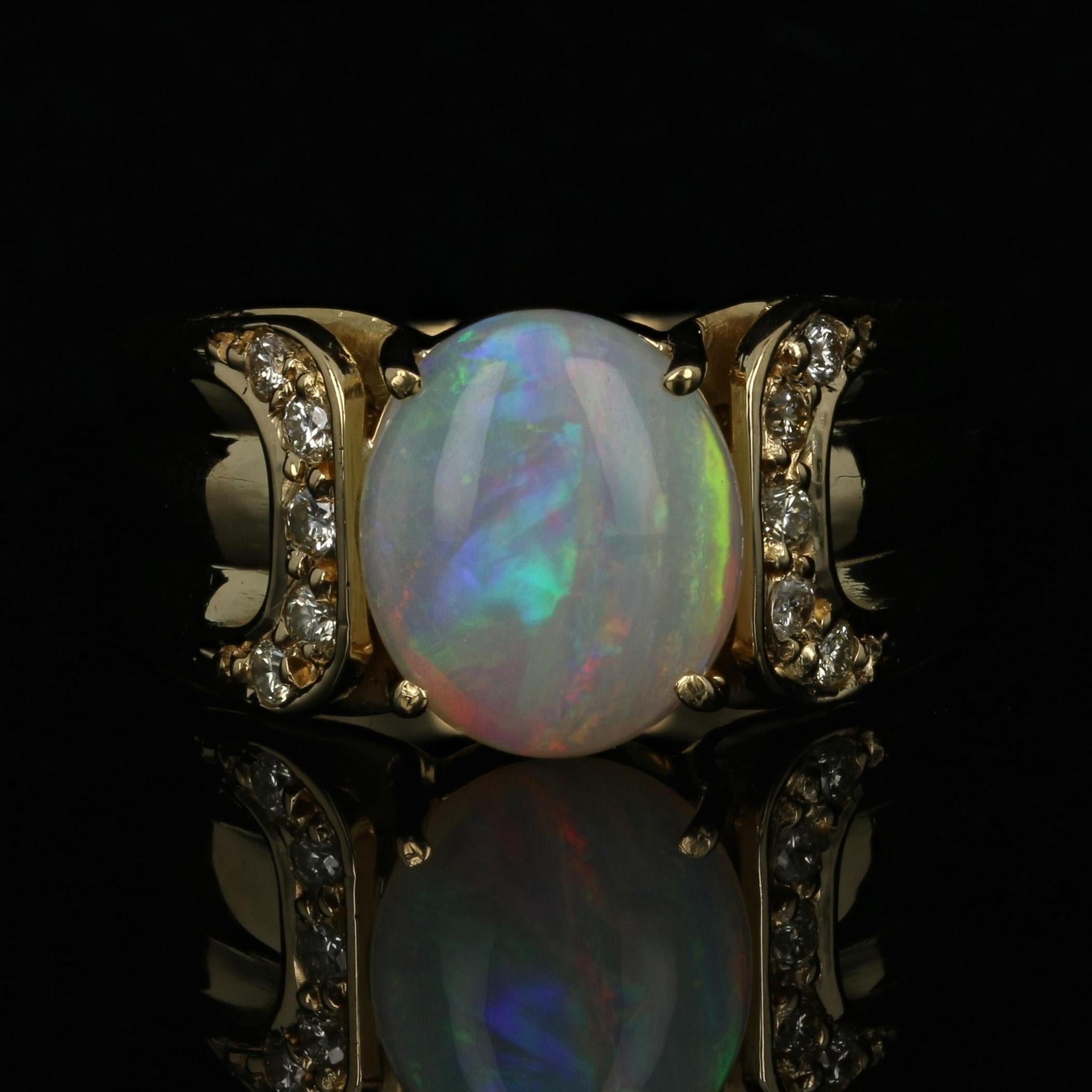 Size: 6 3/4
Sizing Fee: Can be sized up or down 2 sizes for $50

Metal Content: 18k Yellow Gold

Stone Information: 
Genuine Opal 
Carat(s): 1.60ct
Cut: Oval Cabochon
Size: 9.7mm x 8.2mm
Origin: Brazil

Natural Diamonds
Carat(s): .15ctw
Cut: Round