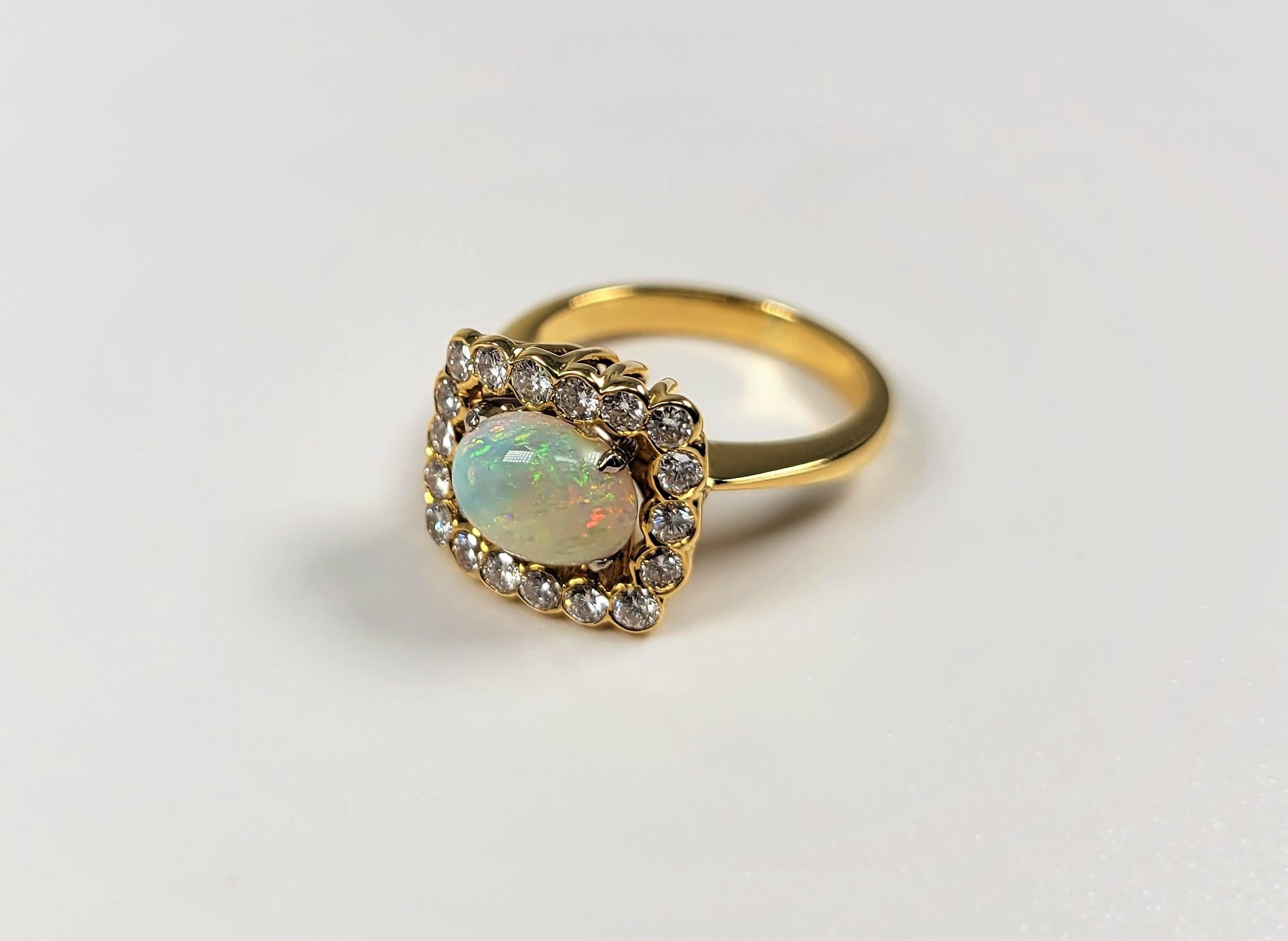 Such a beautiful pay of color in this sweet opal ring!  And the 0.60 carats of diamonds that surround this lovely opal are stunning!  