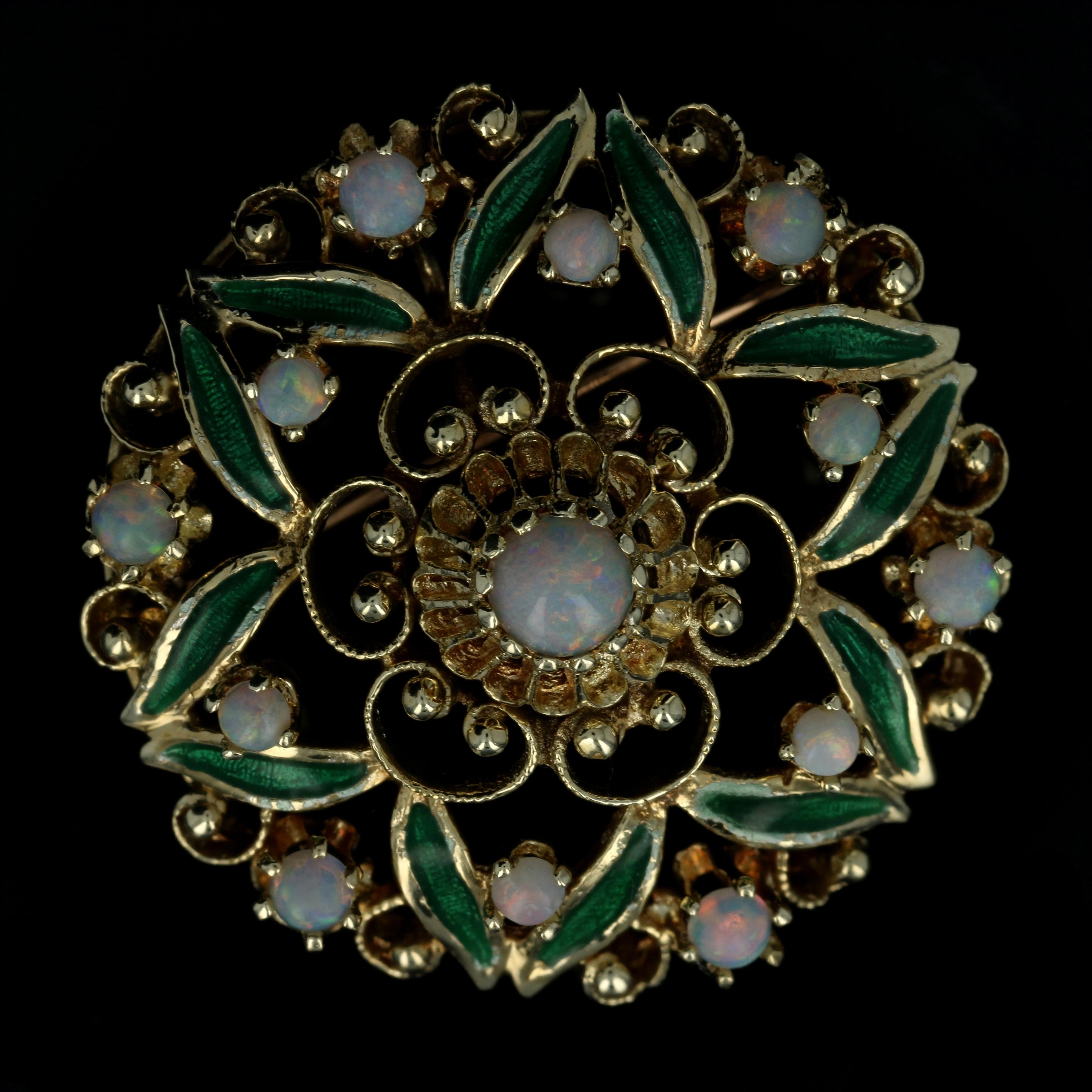 Give your favorite cardigan or blazer a fabulous touch of vintage style with this gorgeous brooch! Composed of 14k yellow gold, this convertible piece showcases a floral design showcasing genuine opals and vibrant green enamel which can be worn as a