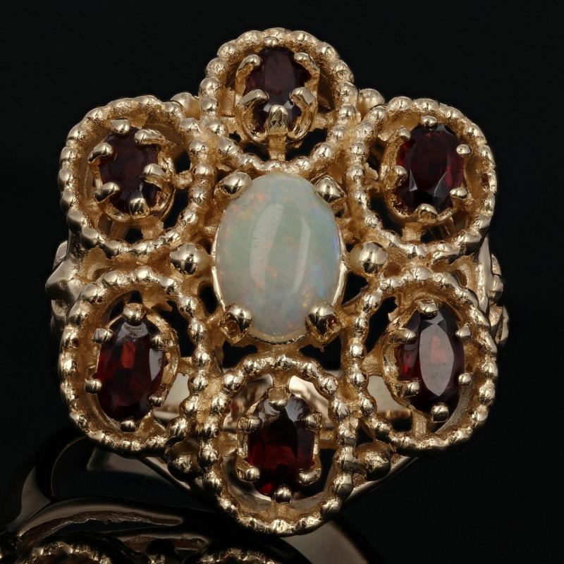 Size: 9 1/2
Sizing Fee: Up 2 sizes for $35 or Down 2 sizes for $30 

Metal Content: 14k Yellow Gold  

Stone Information: 
Genuine Opal 
Carat: .90ct
Cut: Oval Cabochon 
Size: 8mm x 6mm

Genuine Garnets
Carats: 1.50ctw
Cut: Oval 
Color: Red  