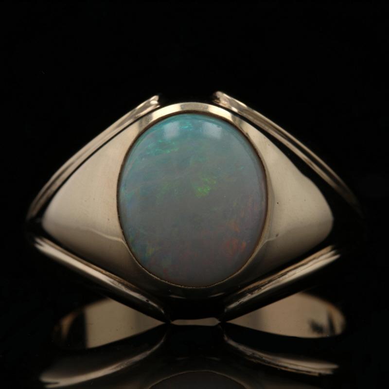 Size: 10 1/4

Metal Content: 10k Yellow Gold

Stone Information
Genuine Australian Opal
Carat(s): 2.80ct
Cut: Oval Cabochon

Style: Solitaire

Measurements
Face Height (north to south): 5/8