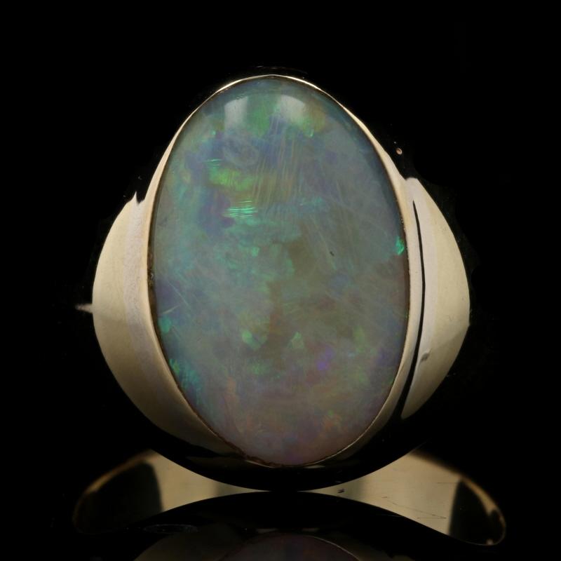 Size: 9 1/4

Metal Content: 18k Yellow Gold

Stone Information
Genuine Australian Opal
Carat: 5.70ct
Cut: Oval Cabochon

Style: Solitaire

Measurements
Face Height (north to south): 3/4