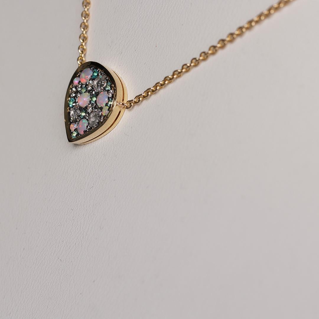 Handcrafted in Belgium, this yellow gold pendant shines with a unique mix of Paraiba Tourmalines, Australian Opals, and sparkling diamonds. Each stone is hand-set by our skilled stone setter, creating a flawless mosaic that catches the light