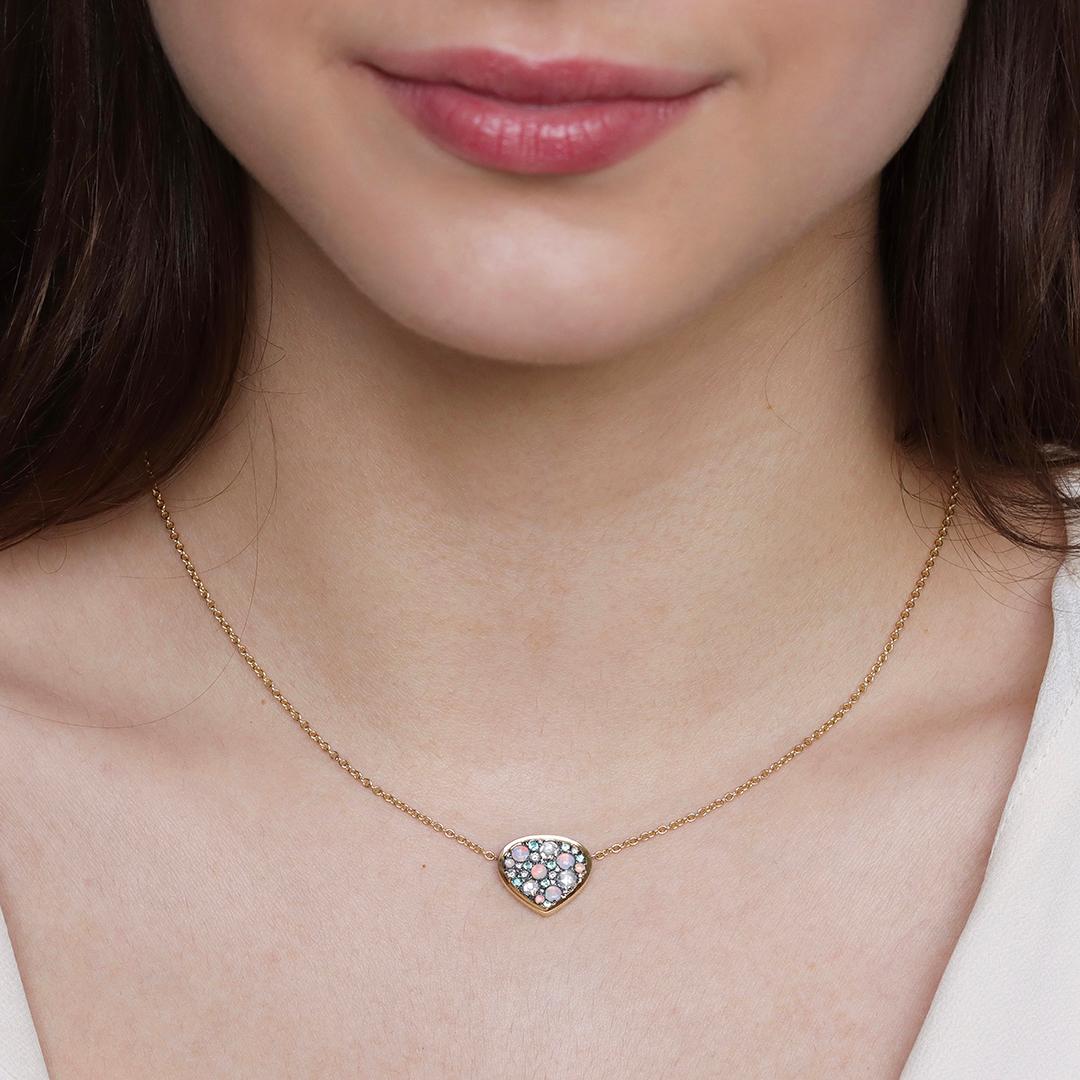 Hecho a mano en Bélgica, este colgante de oro amarillo brilla con una mezcla única de Turmalinas Paraiba, Ópalos Australianos y brillantes diamantes. Cada piedra es engastada a mano por nuestro experto engastador, creando un mosaico impecable que