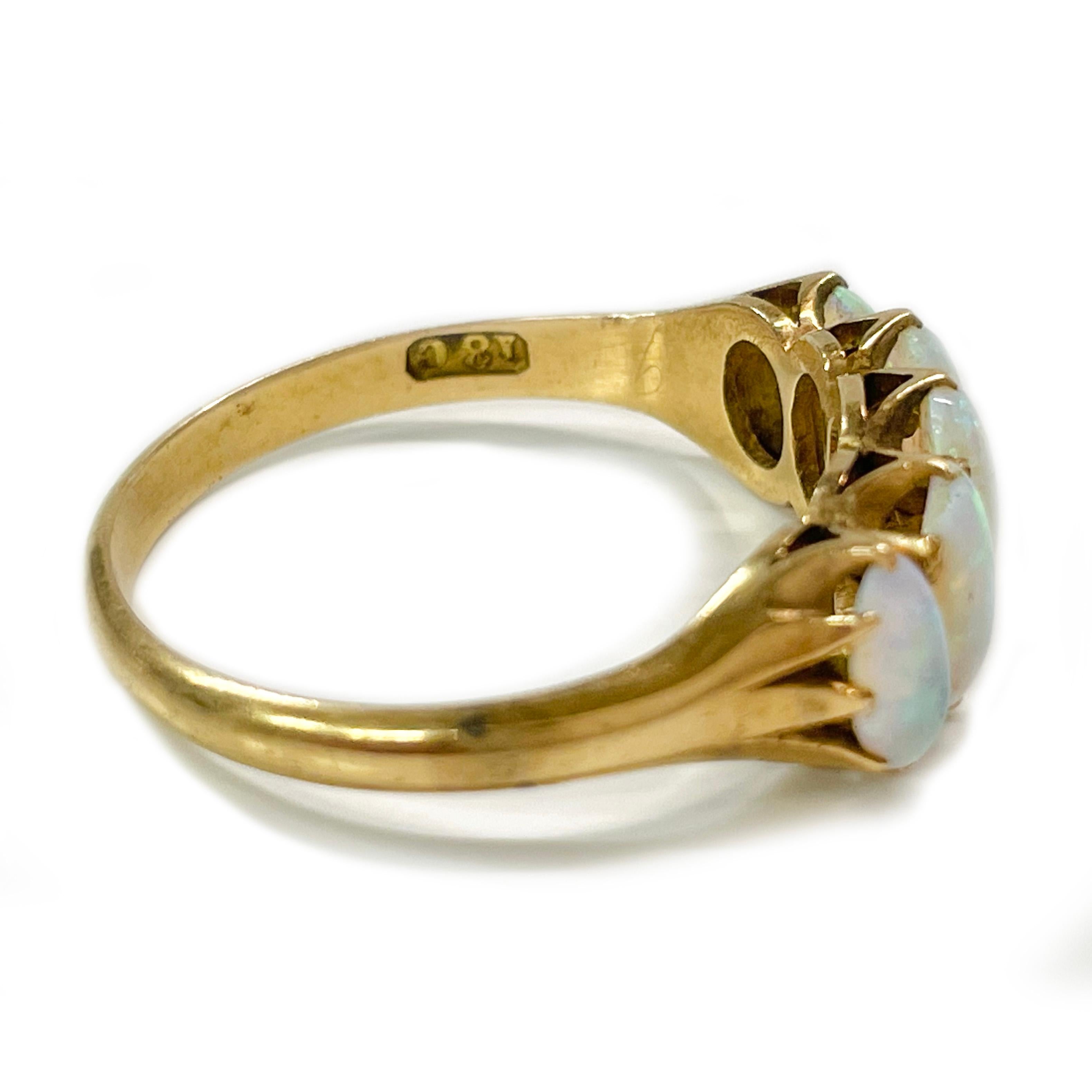 Tested 18 Karat Yellow Gold Opal Ring. This lovely antique ring features five AA quality oval opals prong-set on a raised gallery. One opal measures 7.11 x 4.10, two opals measure 6.37 x 3.68 and two opals measure 5.66 x 3.3mm for a carat total