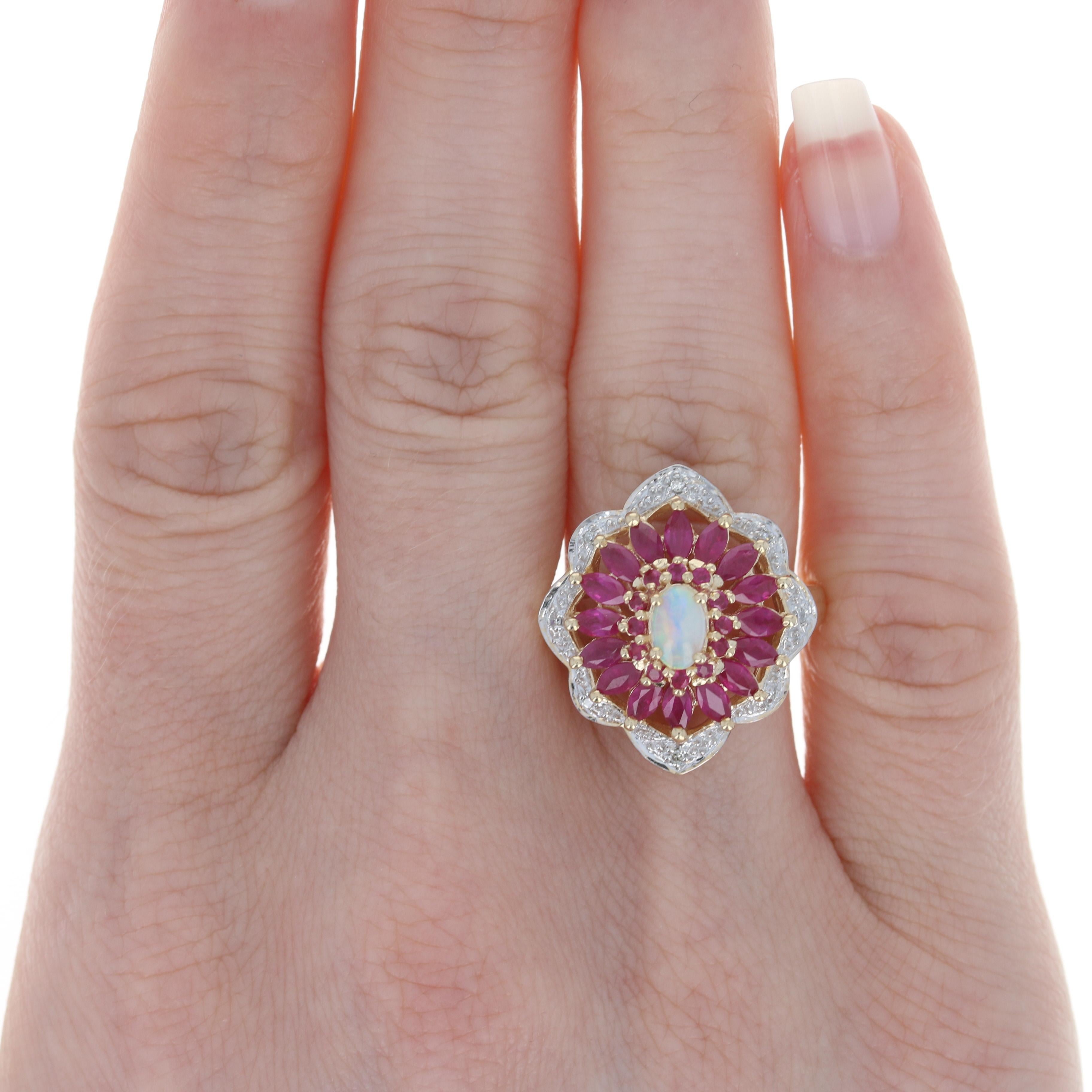 Size: 7
 Sizing Fee: Down or up 1 size for a $30 fee
 
 Metal Content: 10k Yellow Gold & 10k White Gold
 
 Stone Information: 
 Genuine Opal
 Carat: .24ct
 Cut: Oval Cabochon
 Size: 5.9mm X 3.8mm
 
 Genuine Rubies
 Treatment: Heating 
 Carats: