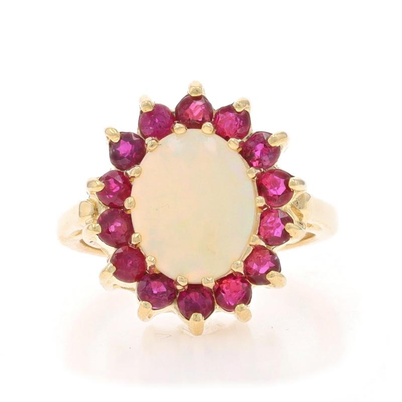 Size: 4 1/2
Sizing Fee: Up 1 1/2 sizes for $40 or Down 1 size for $40

Metal Content: 14k Yellow Gold

Stone Information

Natural Opal
Carat(s): 1.16ct
Cut: Oval Cabochon

Natural Rubies
Treatment: Heating
Carat(s): 1.12ctw
Cut: Round
Color: Pinkish