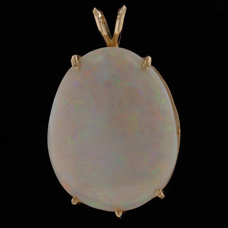 Metal Content: 14k Yellow Gold

Stone Information
Natural Opal
Carat(s): 31.05ct
Cut: Oval Cabochon
Origin: Australia

Total Carats: 31.05ct

Style: Solitaire

Measurements
Tall (from stationary bail): 1 9/16