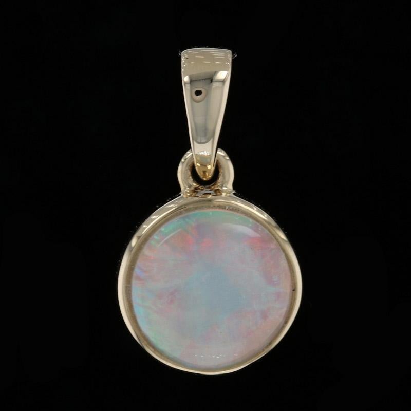 Metal Content: 14k Yellow Gold

Stone Information: 
Genuine Opal 
Carat: .79ct
Cut: Round Cabochon 

Measurements:
Tall (from stationary bail): 13/32