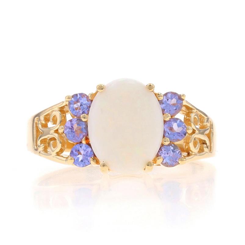 Size: 7 3/4
Sizing Fee: Up 2 sizes for $30 or Down 1 1/2 sizes for $30

Metal Content: 10k Yellow Gold

Stone Information

Natural Opal
Carat(s): 1.15ct
Cut: Oval Cabochon

Natural Tanzanites
Treatment: Routinely Enhanced
Carat(s): .30ctw
Cut: