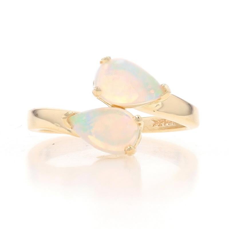 Size: 6
Sizing Fee: Up 4 sizes for $35 or Down 3 sizes for $30

Metal Content: 14k Yellow Gold

Stone Information
Natural Opals
Carat(s): .42ctw
Cut: Pear Cabochon
Origin: Australia

Total Carats: .42ctw

Style: Two-Stone Bypass

Measurements
Face