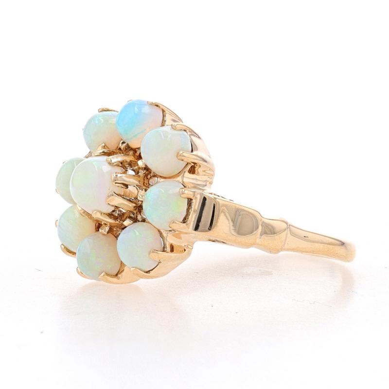 Size: 5 3/4
Sizing Fee: Up 2 sizes for $35 or Down 2 sizes for $30

Era: Vintage

Metal Content: 10k Yellow Gold

Stone Information
Natural Opals
Cut: Round Cabochon
Stone Note: Australian

Style: Cluster Halo Cocktail
Theme: