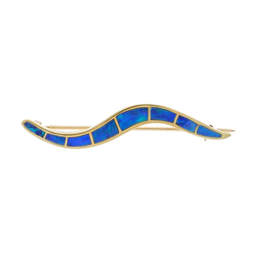 Metal Content: 18k Yellow Gold

Stone Information
Natural Opal
Cut: Inlay
Origin: Australia

Style: Brooch
Fastening Type: Hinged Pin and Whale Tail Clasp
Theme: Wavy Line

Measurements
Tall: 13/32