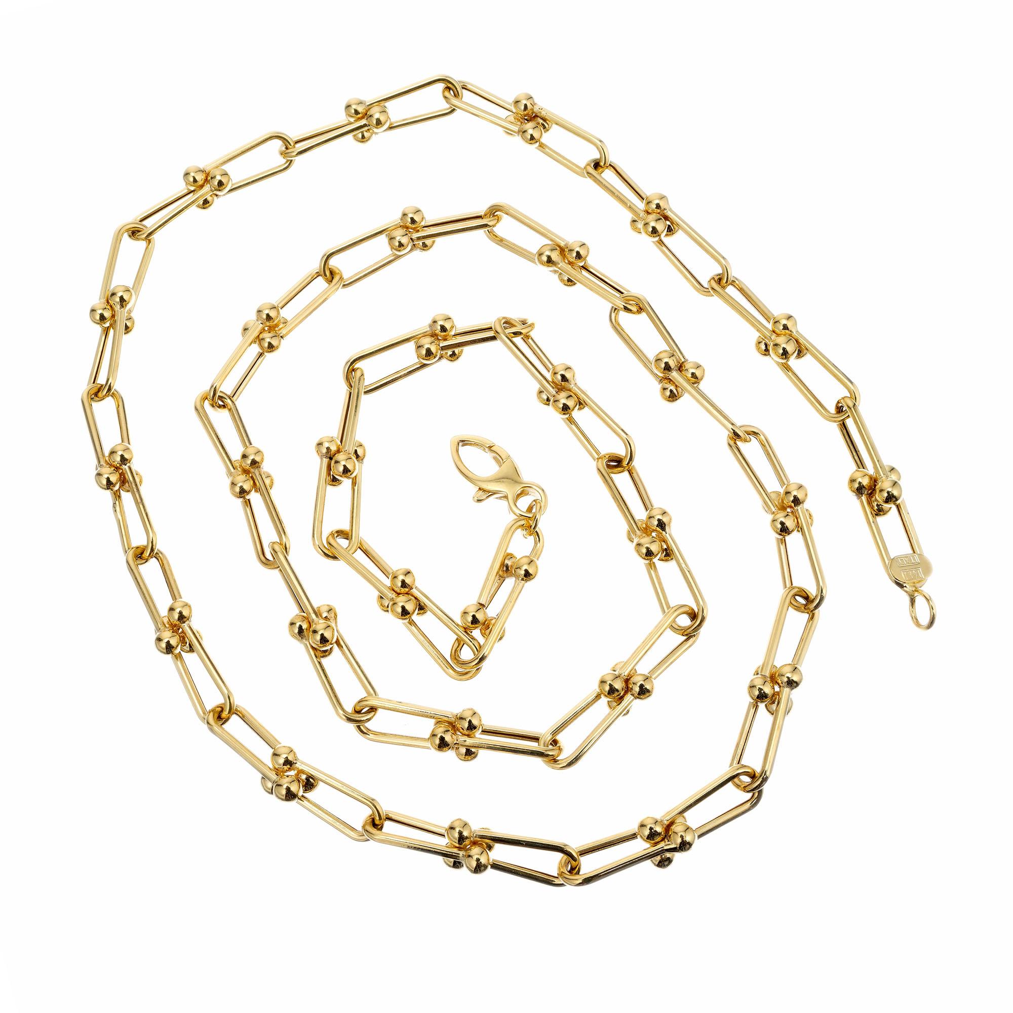 Open oval 14k yellow gold link long chain, with gold ball ends. Made in Italy.

14k yellow gold 
Stamped: 14k Italy 
17.1 grams
Total length: 24 Inches
Width: 5.4- 6.1mm 
Thickness/depth: 1.3mm
