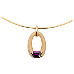 Yellow Gold Oval Pendant with Tension-Set Magenta Sapphire