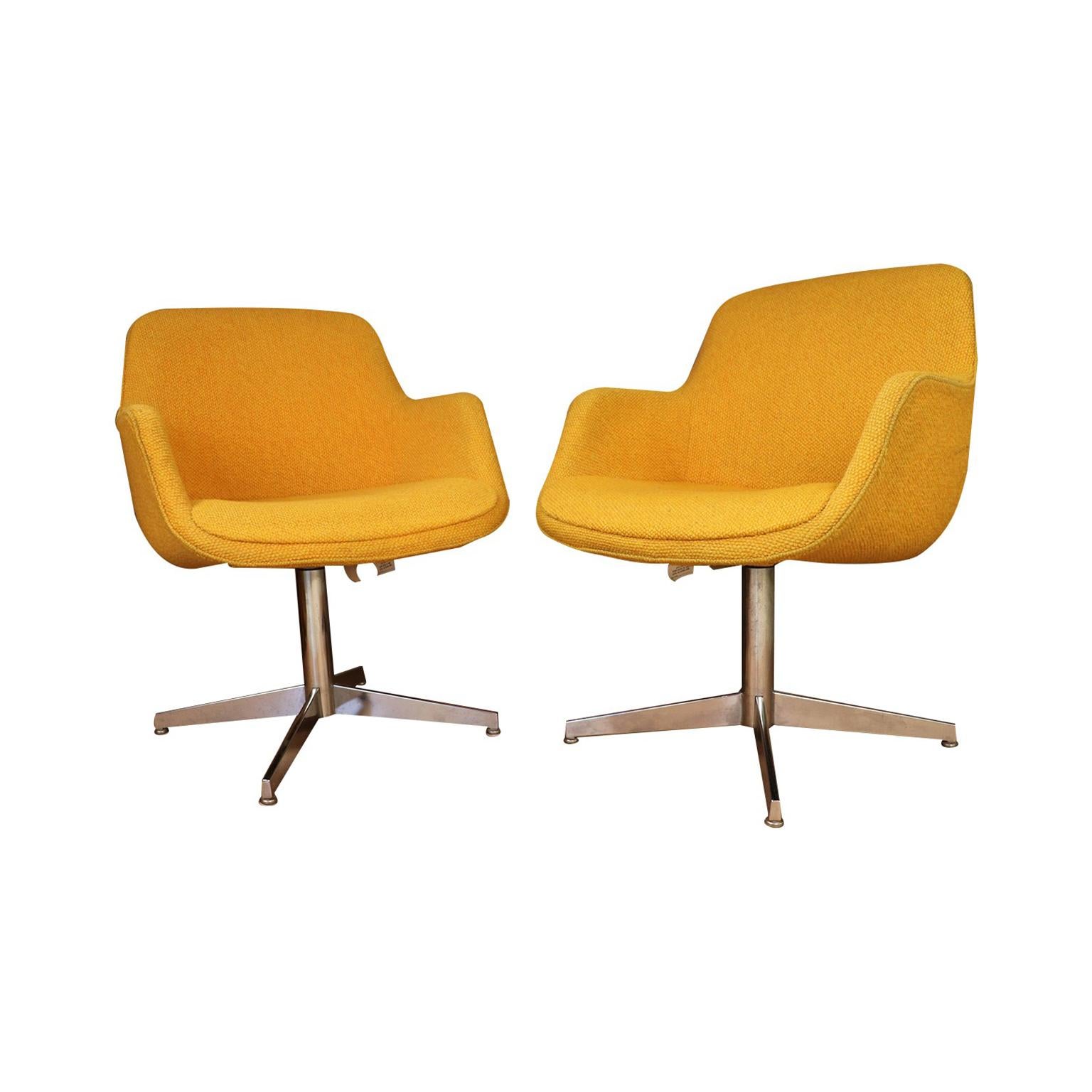 Vibrant pair of Swivel Barrel chairs manufactured by Steelcase, circa 1970s. Feature original striking yellow/gold upholstery and chrome-plated four-leg, swivel base. The chairs swivel effortlessly side-to-side. Modern, lines cradle the body