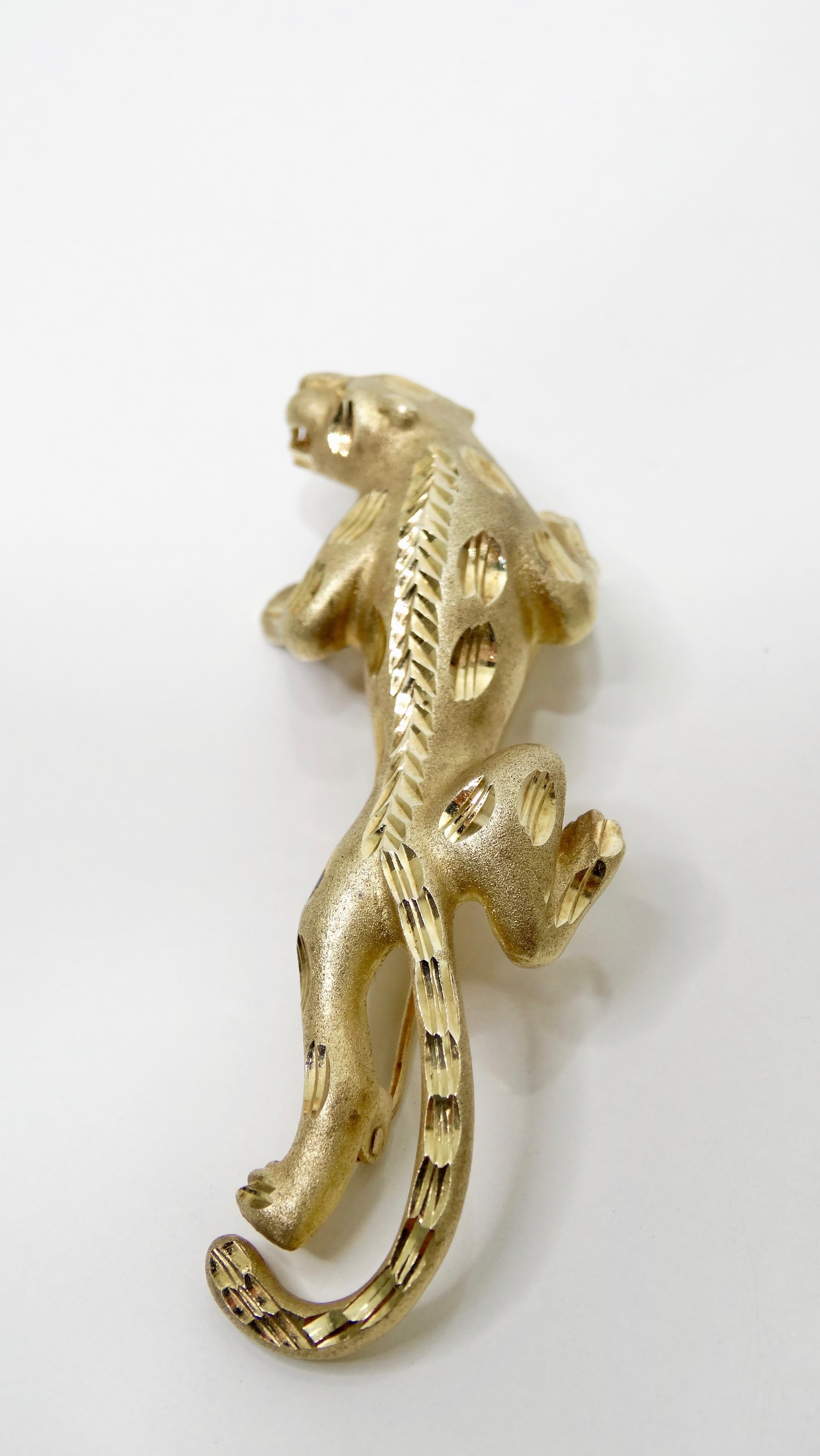 Accent your jacket with this stunning panther brooch! Circa late 20th century, this chic 14k Yellow Gold brooch is in the shape of a crawling panther with cut out details. Stamped 14k under pin. Timeless and versatile, this brooch can be worn with
