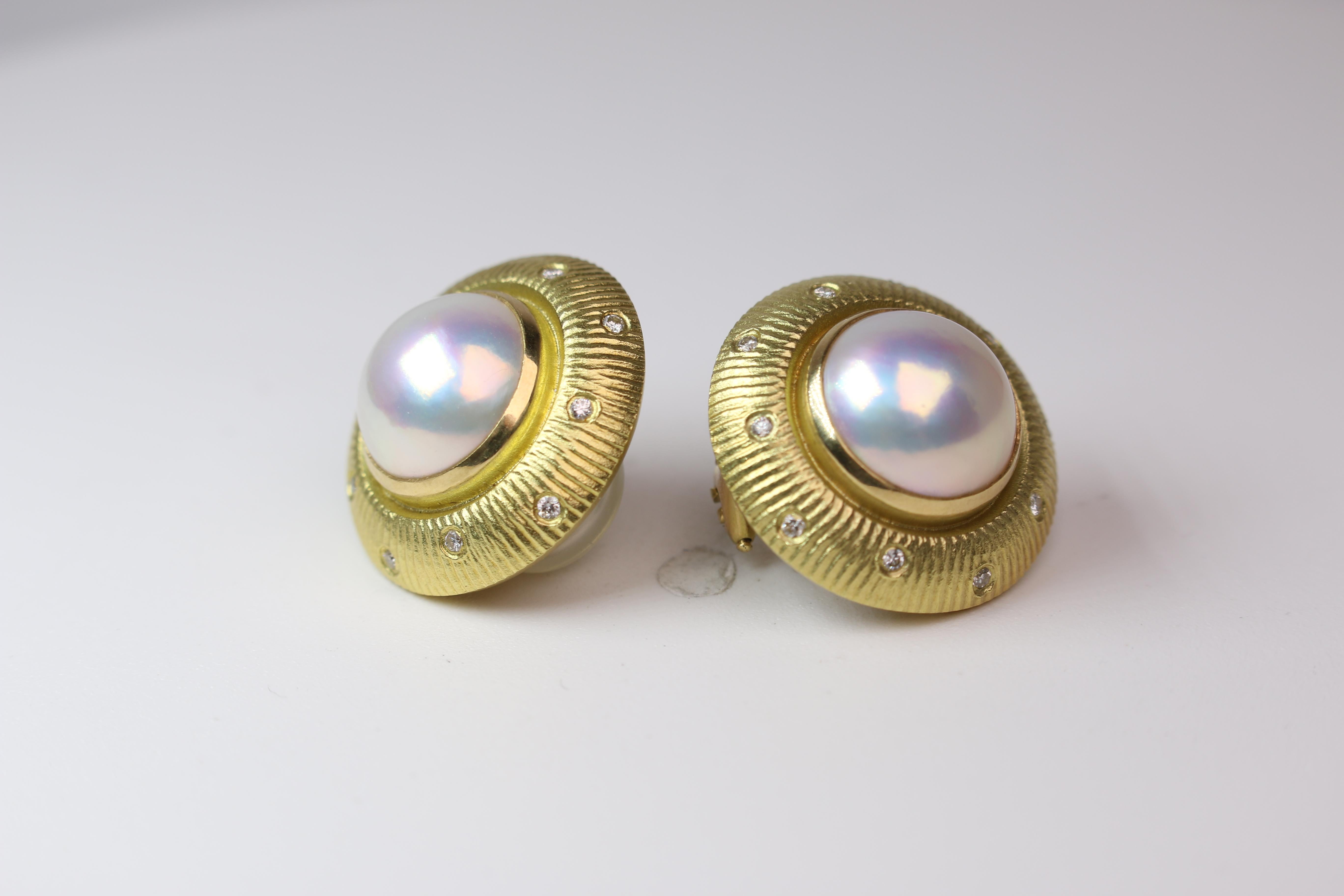 This set of Mabe pearl and Diamond Earrings set in 18k Yellow gold comes from Paul Morelli and are absolutely stunning on the ear. The earrings weigh in at 20.7gs and measure 7/8ths an inch in diameter. The pearls are 12mm wide while the 12 round