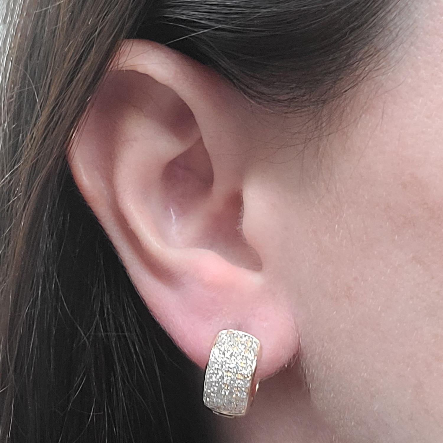 14 Karat Yellow Gold Rounded Pave Huggie Hoop Earrings Featuring 64 Round Brilliant Cut Diamonds Of VS Clarity & G/H Color Totaling Approximately 1.00 Carat. Finished Weight Is 7.8 Grams. Post With Hinged Snap Back.