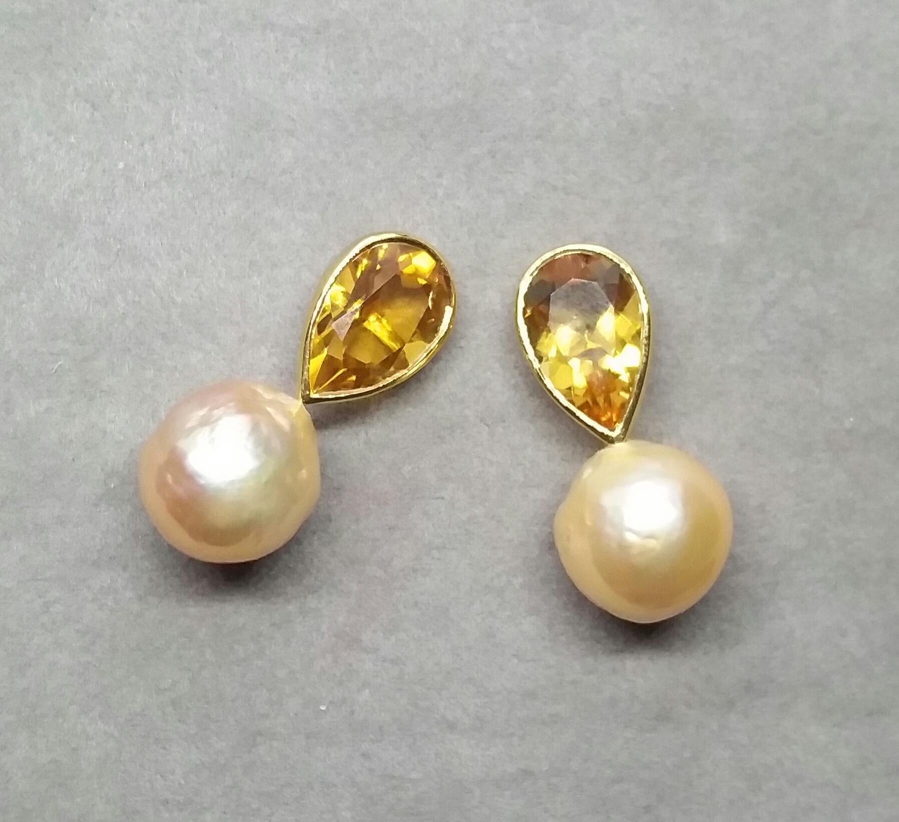 These simple but elegant and completely handmade earrings have 2 Pear Shape Faceted  Natural Citrines measuring 7 x 12 mm set in 14 Kt yellow gold bezel at the top to which are suspended 2  Natural Cream Color Baroque Pearls  12 mm in diameter

In