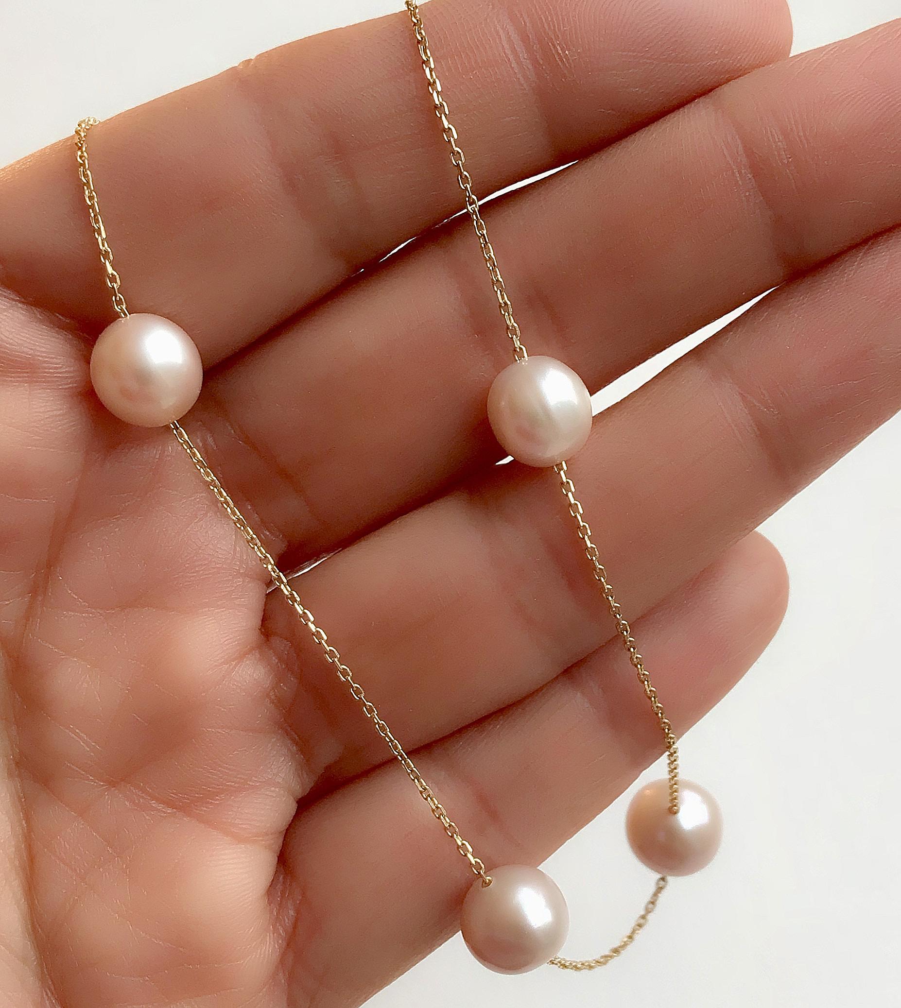 Set of seven freshwater cultured pearls joined to each other by a solid gold chain. 
Each pearl is unique due to its nature. They may vary in shapes and colours from pastel shades of peach, pink and creamy white. We have tried our best to match each