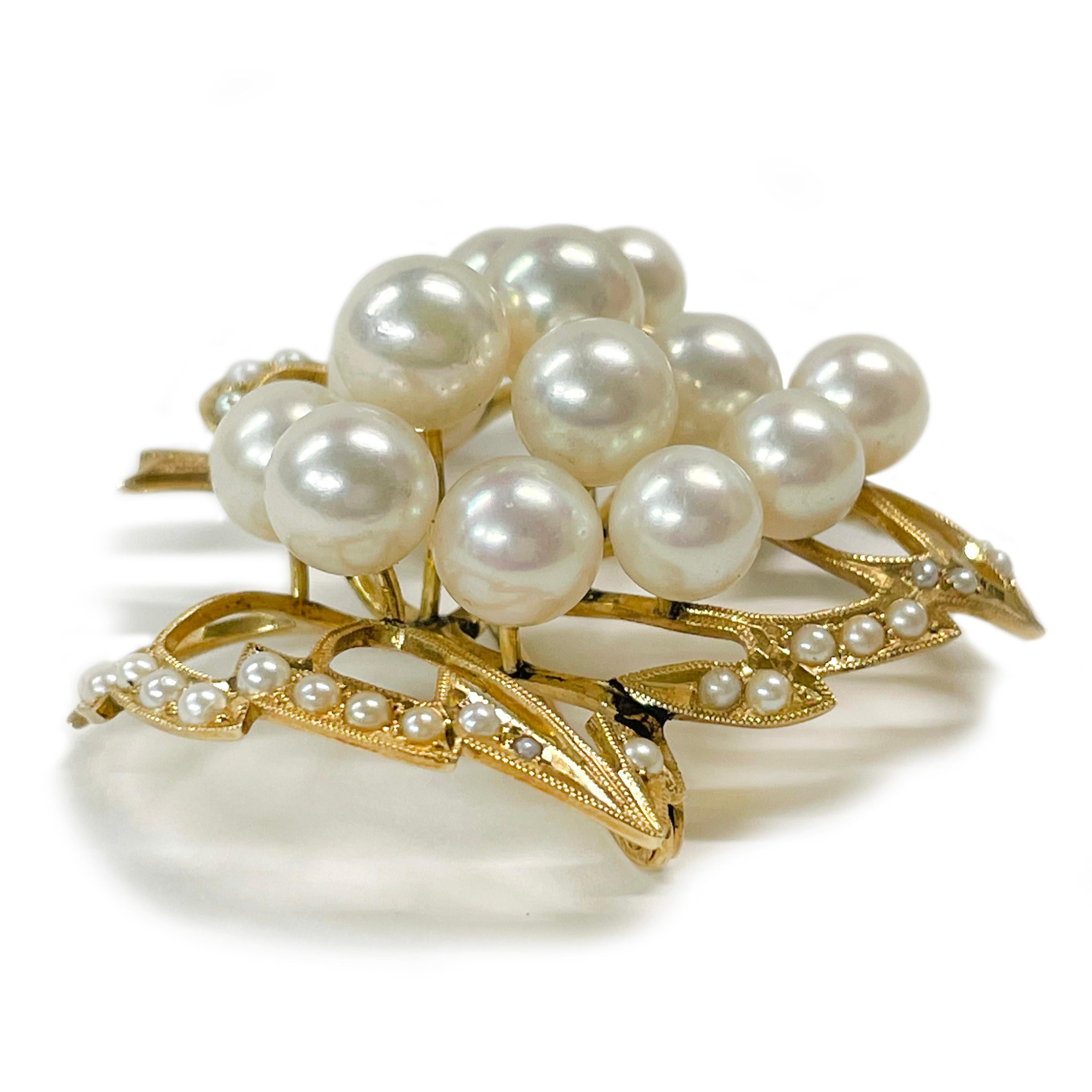 14 Karat Yellow Gold Pearl Cluster Leaf Brooch. This brooch features thirteen 6.5 and 7mm cultured pearls. The pearls are white with pinkish tones and they have good clean luster with only light blemishes. The pearls are set atop a gold leaf outline