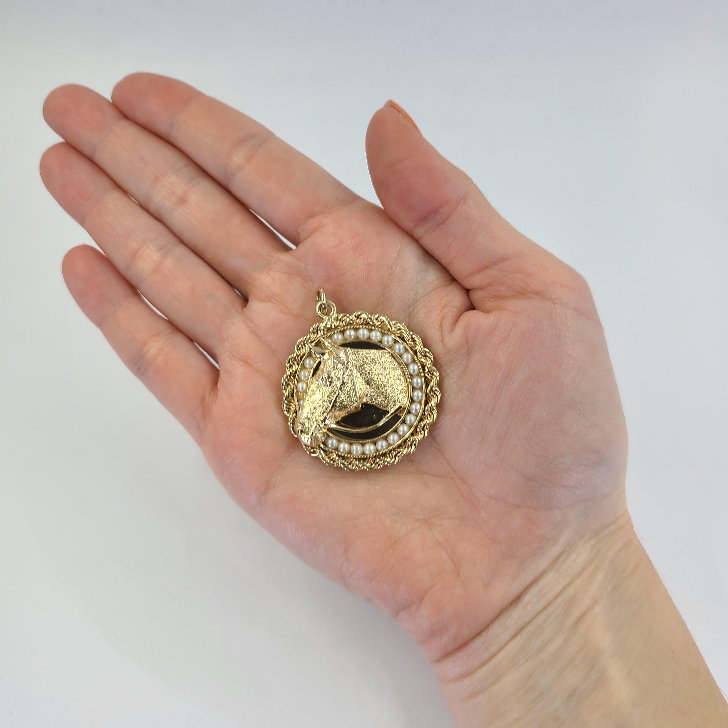 14 Karat Yellow Gold Pendant Featuring A Horse Head Surrounded By 25 Cultured Pearls & Rope Design. 1.5 Inch Diameter. Finished Weight Is 16.7 Grams.