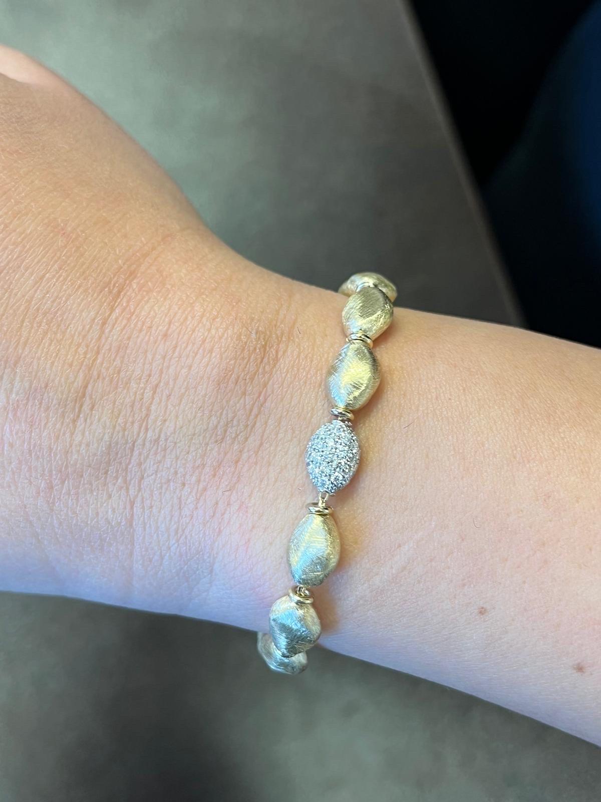 Italian made pebble style bracelet set in 14K yellow gold. The diamond setting part is in white gold. The carat weight is 0.52. Stones are G the clarity is SI1-SI2.