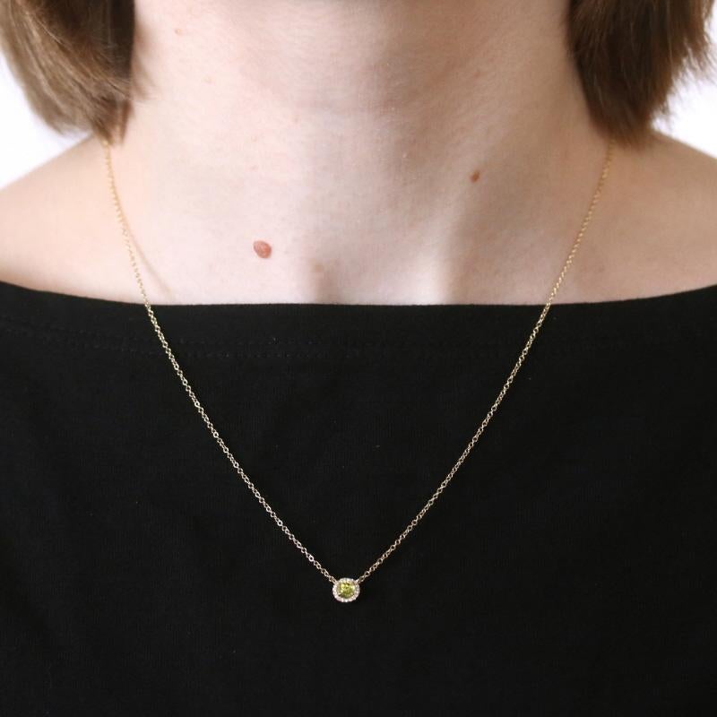 Metal Content: 14k Yellow Gold  

Stone Information: 
Natural Peridot
Carat: 31ct
Cut: Round Rose
Color: Green

Natural Diamonds
Carats: .05ctw
Cut: Single
Color: G - H   
Clarity: VS1 - VS2

Total Carats: .36ctw

Style: Attached Halo Pendant 
Chain