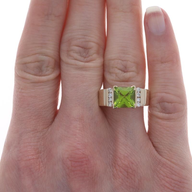 Size: 7

Metal Content: 14k Yellow Gold

Stone Information

Natural Peridot
Carat(s): 2.40ct
Cut: Princess
Color: Green

Natural Diamonds
Carat(s): .20ctw
Cut: Round Brilliant
Color: K - L
Clarity: SI2 - I1

Total Carats: 2.60ctw

Style: Solitaire
