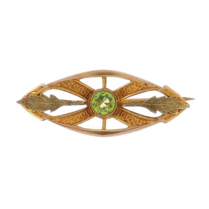 Era: Edwardian
Date: 1900s - 1910s

Metal Content: 10k Yellow Gold & 10k Green Gold

Stone Information

Natural Peridot
Carat(s): .26ct
Cut: Round
Color: Green

Total Carats: .26ct

Style: Brooch
Fastening Type: Hinged Pin and C-Clasp
Theme: