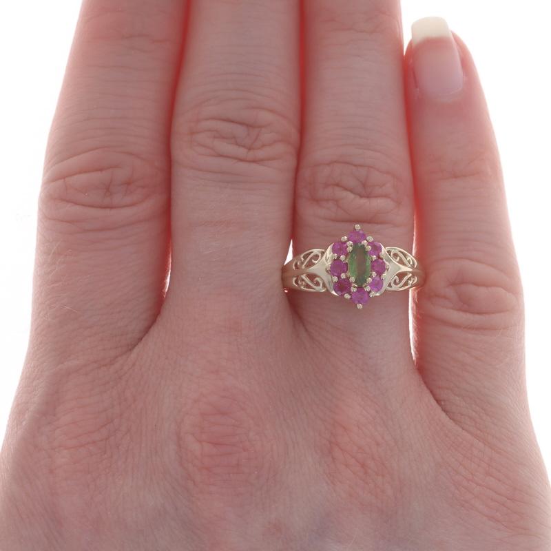 Size: 8 1/4
Sizing Fee: Up 2 1/2 sizes for $35 or Down 2 sizes for $35

Metal Content: 14k Yellow Gold

Stone Information

Natural Peridot
Carat(s): .25ct
Cut: Marquise
Color: Green

Natural Pink Sapphires
Treatment: Heating
Carat(s): .56ctw
Cut: