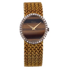 Yellow Gold Piaget Watch with Diamond Bezel and Oval Tiger's Eye Dial