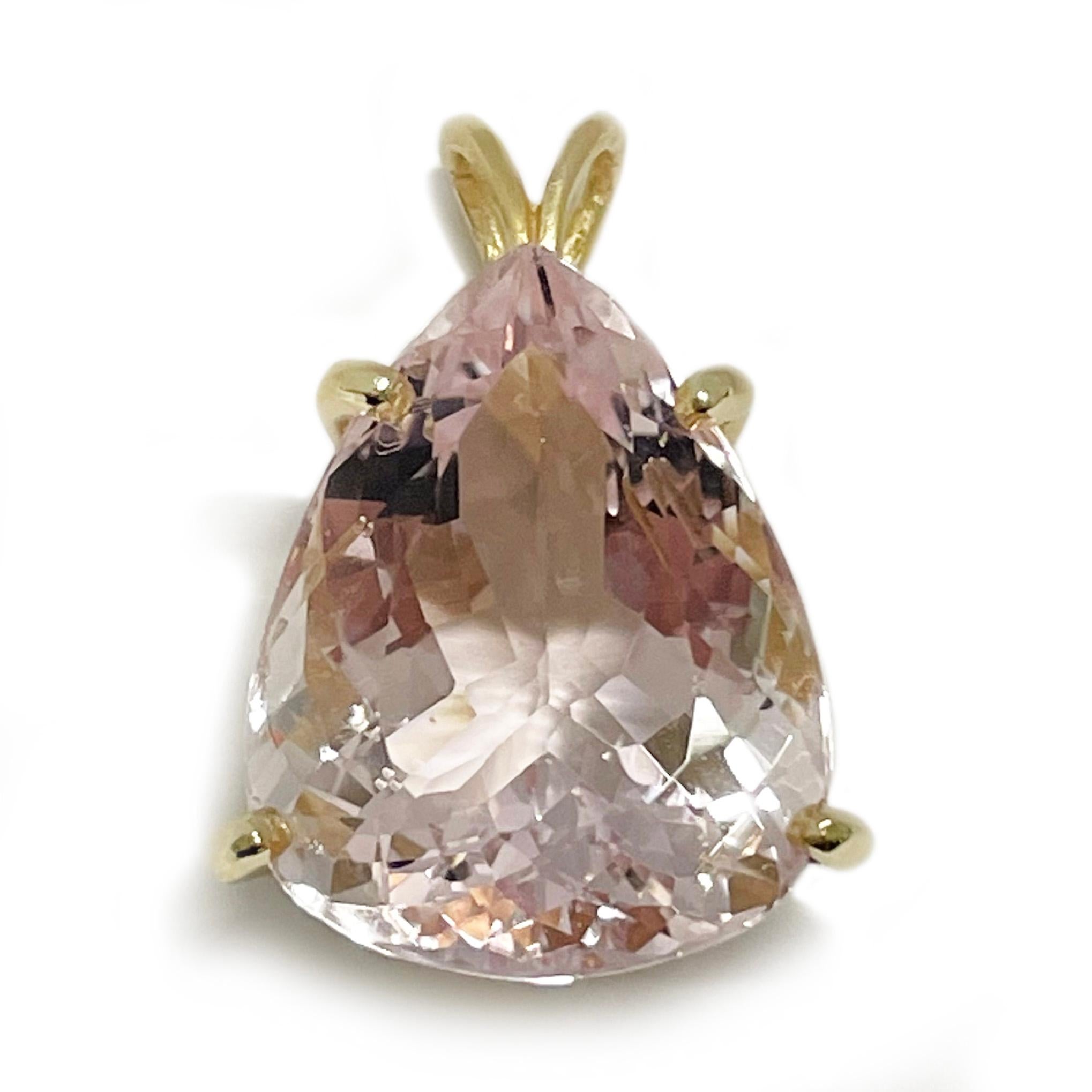 14 Karat Yellow Gold Pink Morganite Pendant. This lovely pendant features an oval-shaped light pink Morganite set in a double basket with a rabbit bail. The Morganite stone measures 19.4 x 14.3 x 9.3 mm for a carat total weight of 14.86ct. The