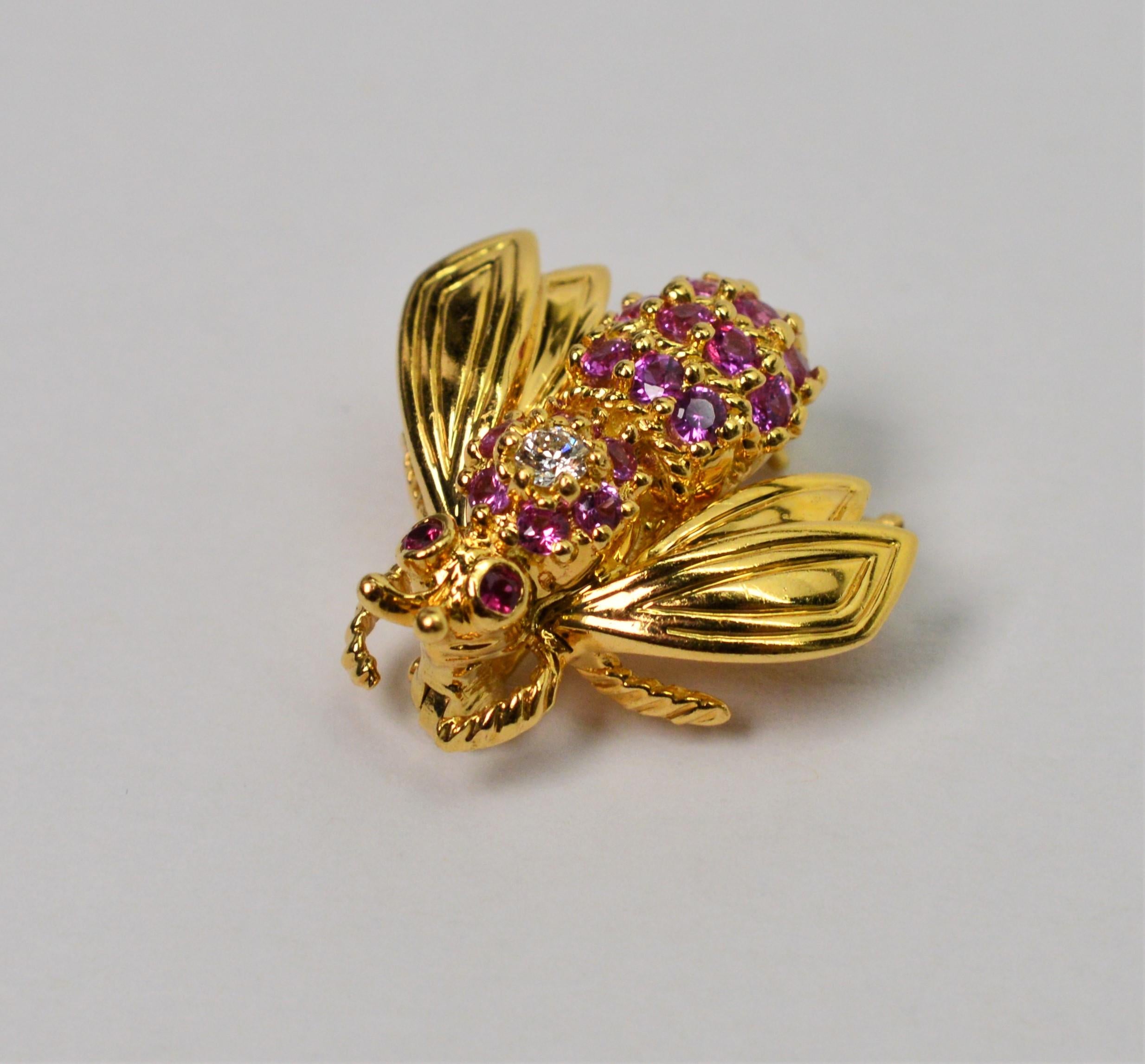 Adorable eighteen karat 18K yellow gold Tiffany & Company Bee Pin Brooch with pink sapphire and diamond back with ruby eyes. Measures approximately 3/4 inch long and about the same wing to wing. Mint condition.
 