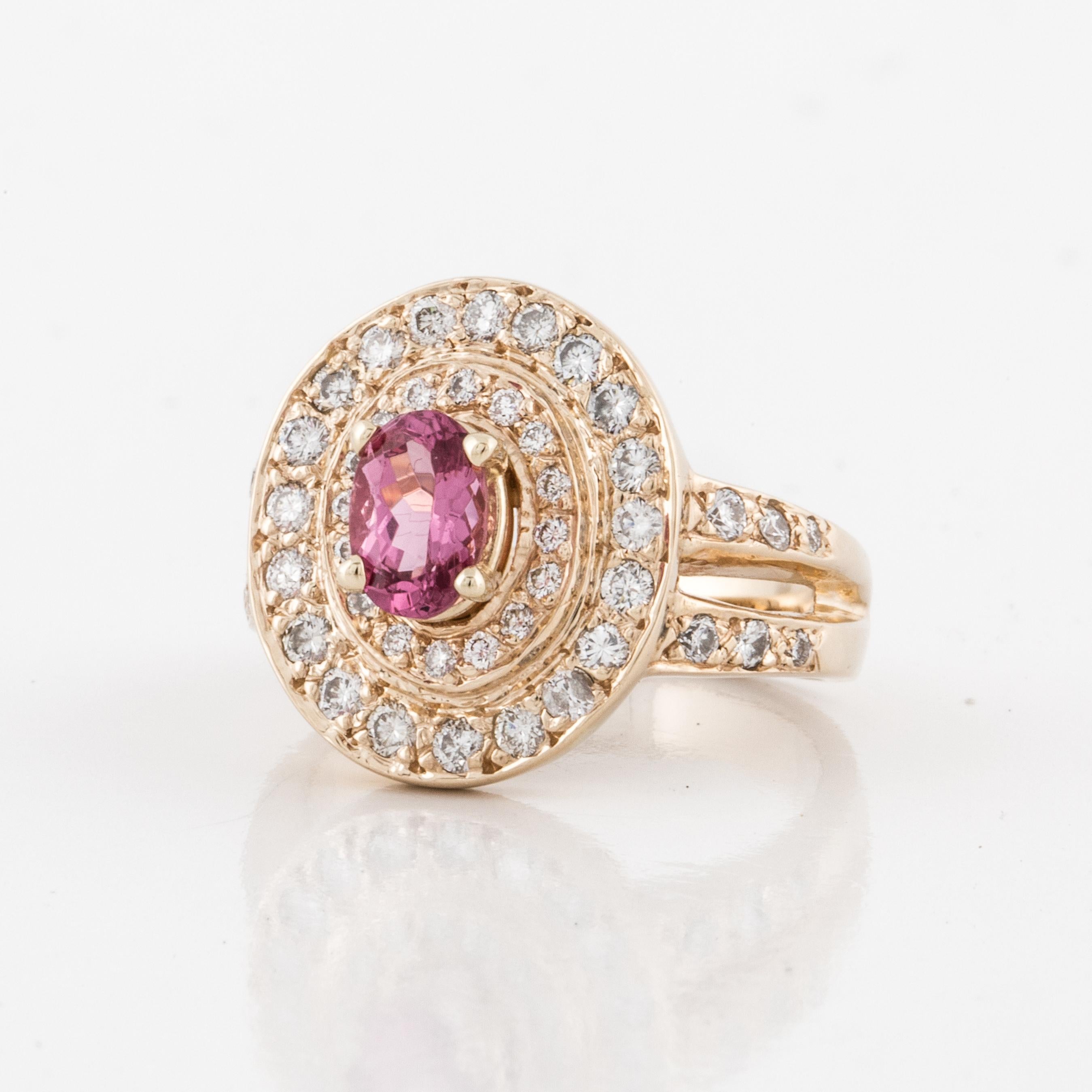 14K yellow gold ring featuring a pink spinel and diamonds.  The oval pink spinel totals 0.90 carats.  There are forty-eight (48) round diamonds totaling 1.0 carats; they are G-H in color and VS1-2 in clarity.  Ring is currently a size 7-1/4. 