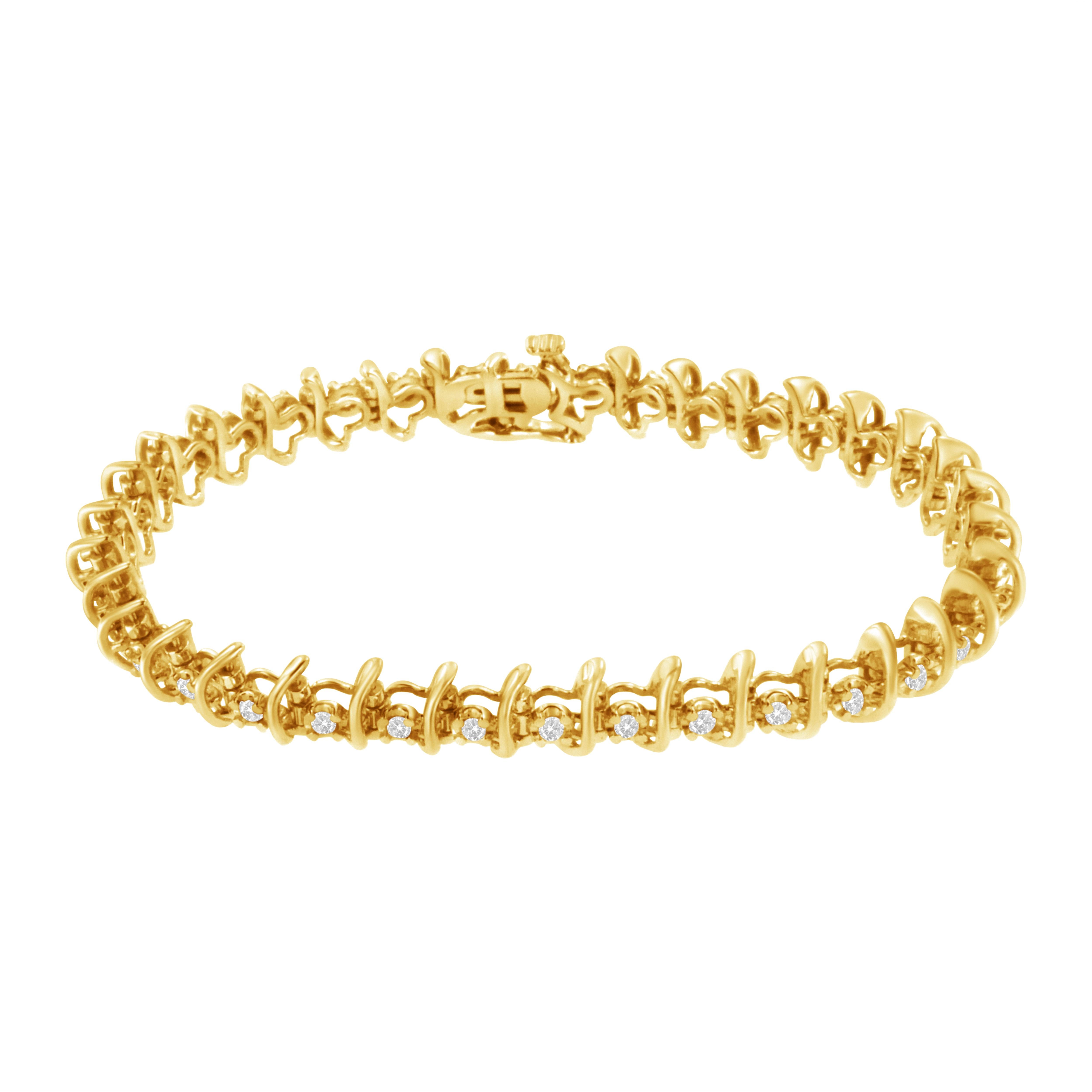 This glamorous 10k yellow gold plated link bracelet showcases 36 round cut diamonds that sparkle along the length of the bracelet. 1 carat TDW of prong set diamonds alternate with soft waving ribbons of warm yellow gold. The bracelet secures with a