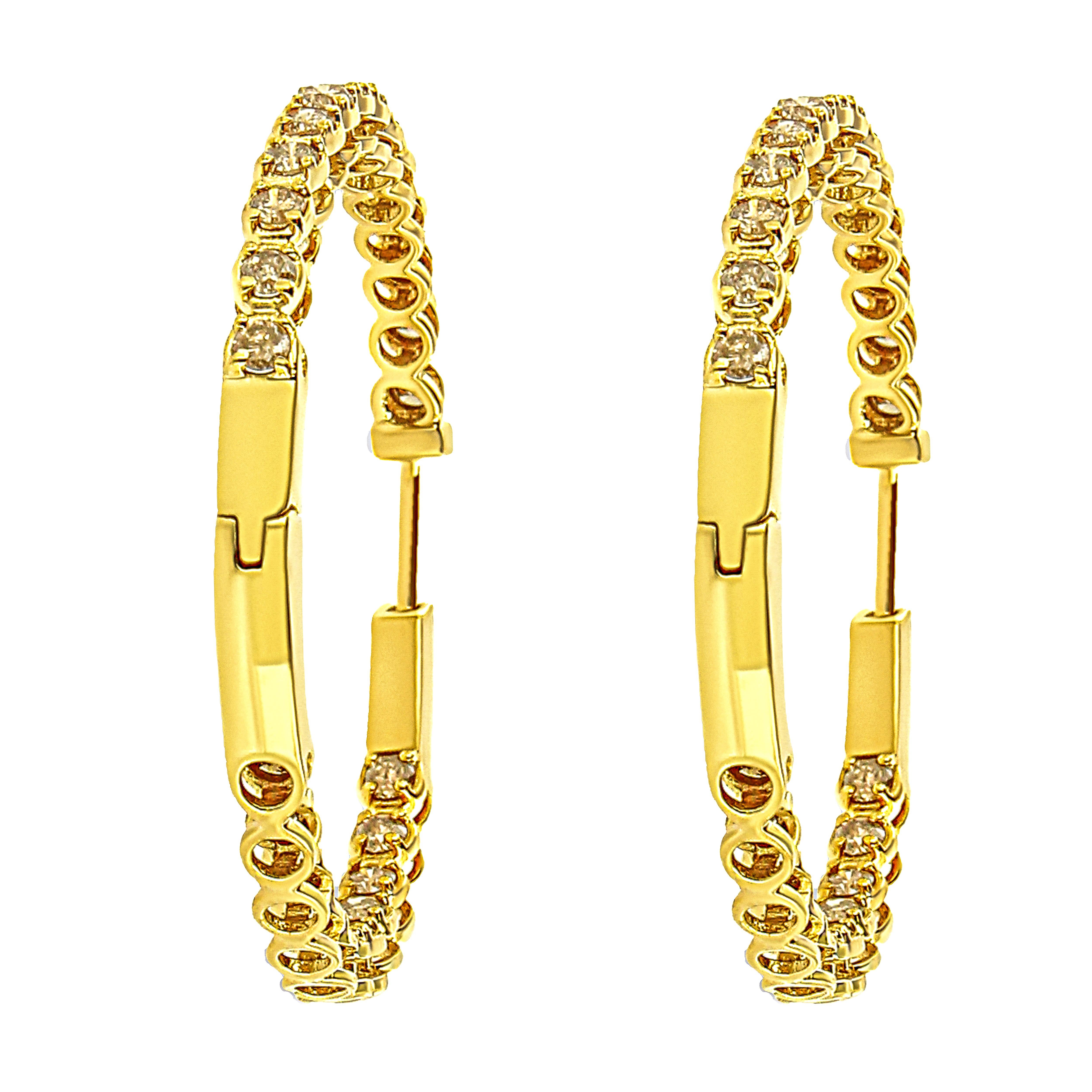 Treat yourself to luxury with these dazzling diamond hoop earrings crafted in 10k gold plated .925 sterling silver. The earring is captivatingly embellished with 50 bright, round-cut 3.00 Cttw diamonds set along the outside upper front and inside