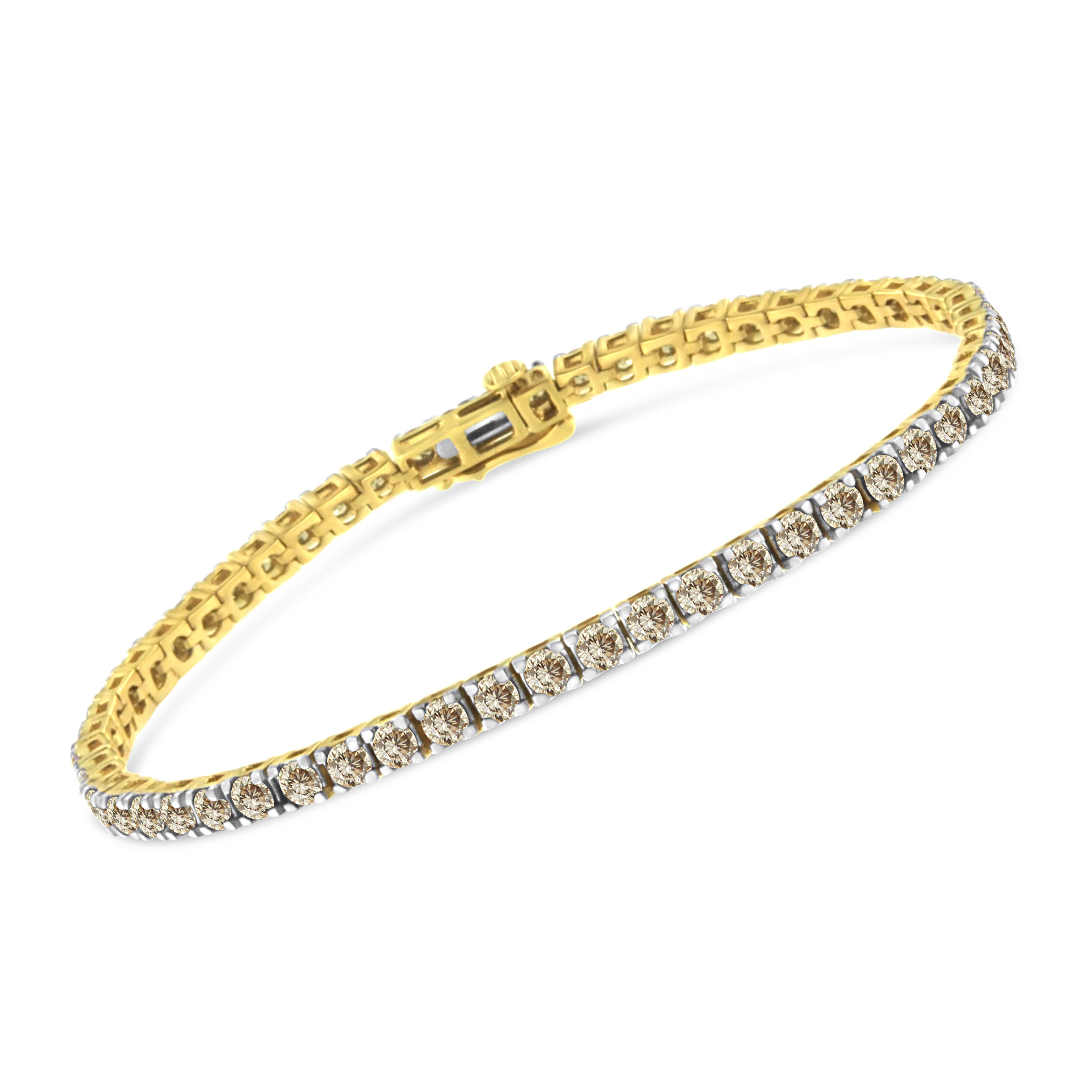 This tennis bracelet has a classic and timeless design. Fashioned in 14k yellow gold plated sterling silver, this design features 5ct TDW of glimmering round cut diamonds. 55 prong set diamonds make up this piece that secures with a box with clasp
